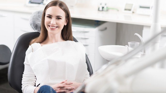 Happy woman in dental treatment chair