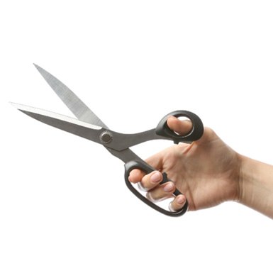 Closeup of patient holding black scissors